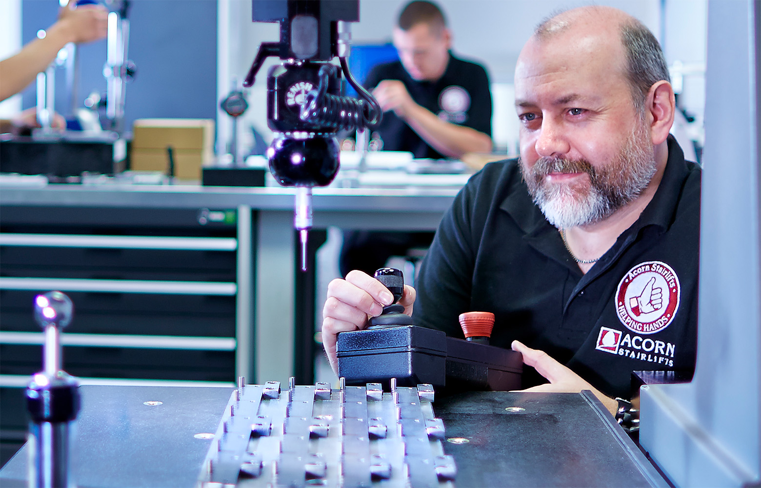 Acorn Stairlifts Technician Using Remote to Build Lift